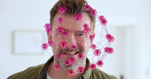 Mature man wearing augmented reality network overlay in bright home workspace