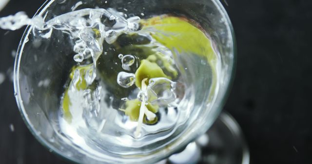 Splashing Water in Martini Glass with Lemon Twist Garnish - Download Free Stock Images Pikwizard.com