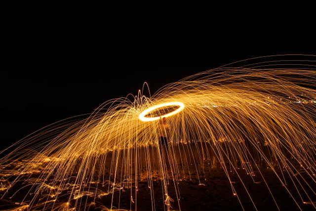 Person Spinning Fire Sparks at Night in Stunning Long Exposure - Download Free Stock Photos Pikwizard.com