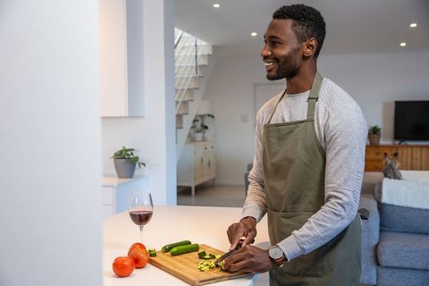 Man Preparing Zucchini in Modern Kitchen