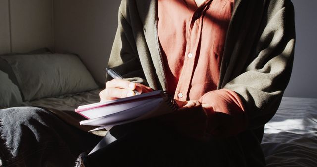 Person Writing in Notebook in Sunlit Room - Download Free Stock Images Pikwizard.com