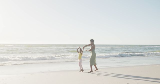 Mother and Daughter Dancing on Sunny Beach - Download Free Stock Images Pikwizard.com