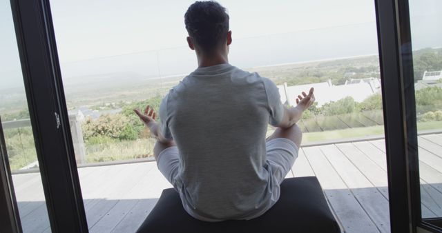 Man Practicing Meditation on Balcony with Scenic View - Download Free Stock Images Pikwizard.com