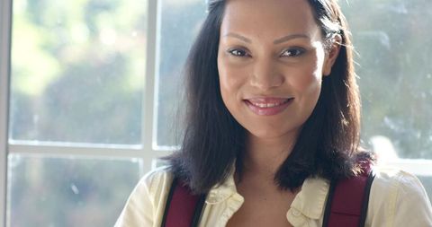 Confident Student Standing at Bright Window in Tranquil Environment