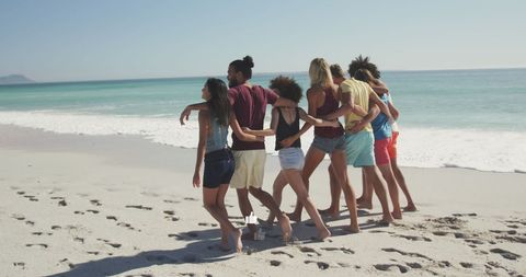 Diverse Friends Enjoying Beach Retreat Embracing Together