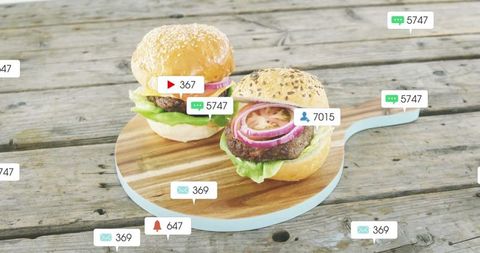 Gourmet burgers with social media icons in rustic setting