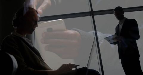 Silhouette businesswoman typing on laptop in modern workspace