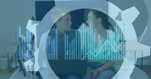 Couple analyzing financial data with laptop and graphs