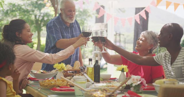 Multigenerational family toasting with wine at outdoor meal - Download Free Stock Images Pikwizard.com