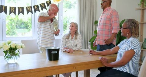 Senior Friends Celebrating Retirement at Home with Champagne