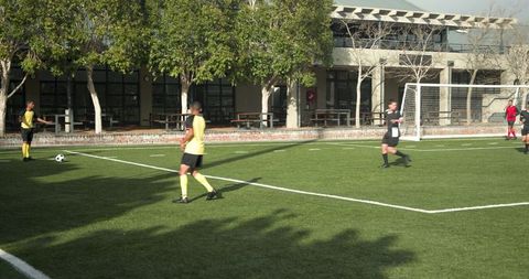 Soccer Players Practicing for Match on Sunny Day
