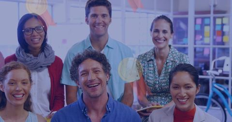 Diverse team of colleagues smiling in contemporary office space