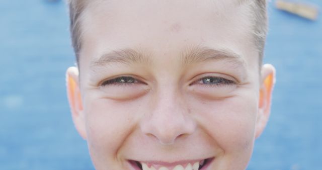 Close-Up of Smiling Boy with Blue Background - Download Free Stock Images Pikwizard.com