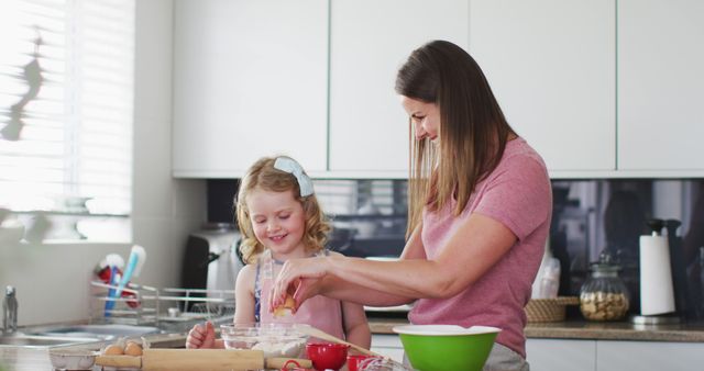 Mother and Daughter in Kitchen Baking Together with Smiles - Download Free Stock Images Pikwizard.com