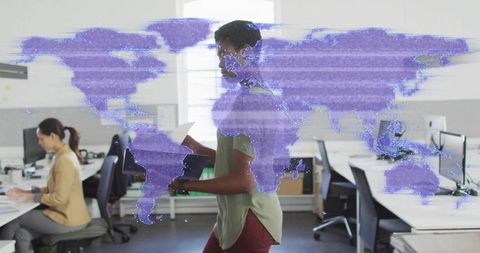 Walking employee reading document with holographic purple world map overlay in open workspace