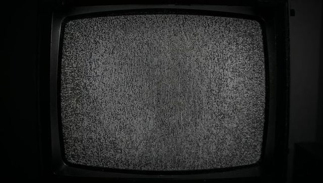 Flickering CRT Television with Static Noise in Dimly Lit Room