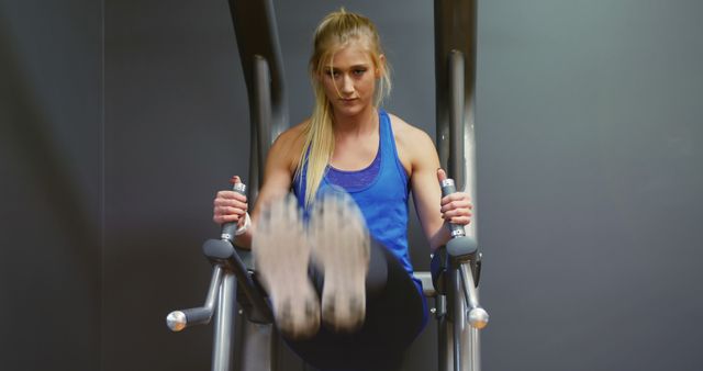 Focused Woman Exercising On Hanging Leg Raise Machine In Gym - Download Free Stock Images Pikwizard.com