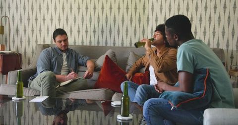 Friends Relaxing and Socializing with Drinks in Cozy Living Room