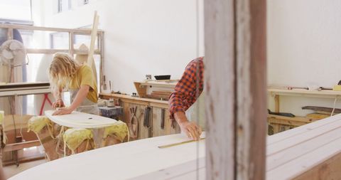 Surfboard Makers Crafting Boards in Local Workshop