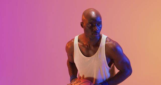 Athletic Man Holding Basketball in Colorful Lighting - Download Free Stock Images Pikwizard.com