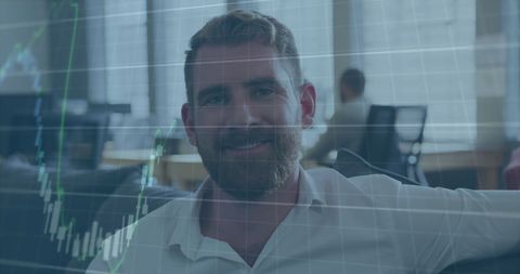 Confident Businessman Overlaid with Financial Graphs in Modern Office