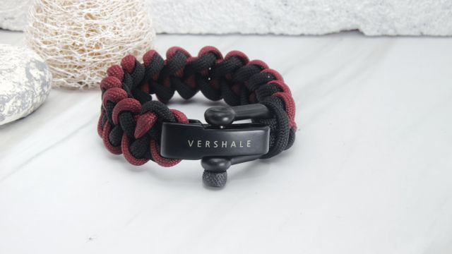 Paracord survival bracelet featuring VERSHALE engraving in black and red. Perfect for outdoor enthusiasts, this rugged and stylish bracelet is suitable for everyday wear as well as emergency situations. Ideal for gifting, camping, hiking, and any adventure.