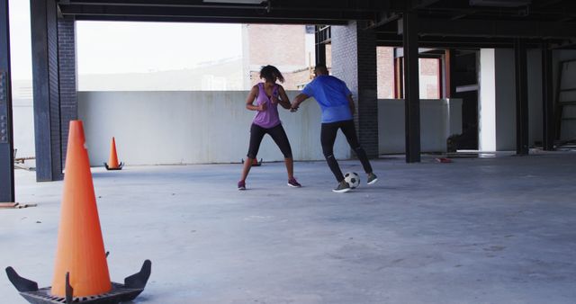 Man and Woman Playing Soccer in Indoor Garage - Download Free Stock Images Pikwizard.com