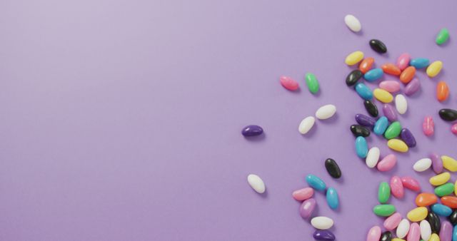 Colorful Jelly Beans Scattered on Pastel Purple Background - Download Free Stock Images Pikwizard.com