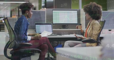 Diverse Businesswomen Collaborating on Financial Data Analysis