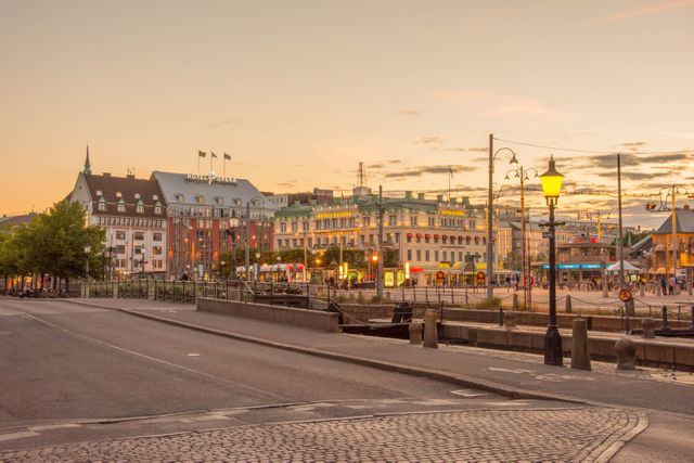 Tranquil Cityscape at Sunset with Colorful Buildings and Lamp Posts - Download Free Stock Images Pikwizard.com