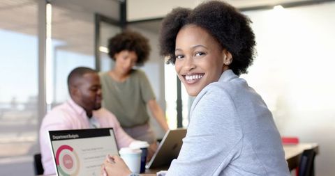 Smiling business professional in modern office collaboration scene