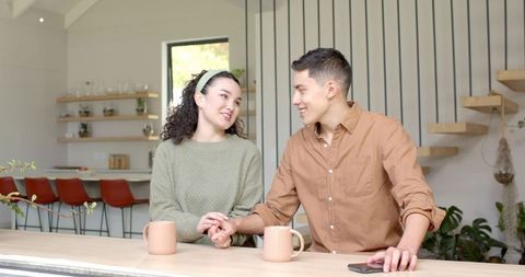 Romantic Couple Enjoying Coffee Together in Modern Kitchen