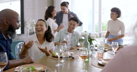 Friends Sharing Joyful Moments at Wedding Reception with Food and Laughter