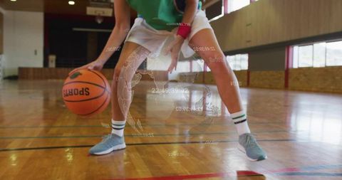 Female basketball player dribbling on indoor court with futuristic sports data overlay