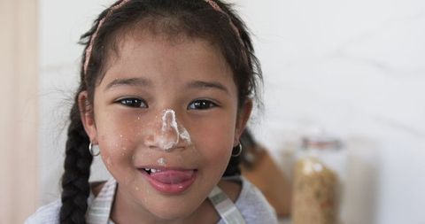 Joyful Girl Embracing Baking, Flour on Face, Spontaneous and Playful