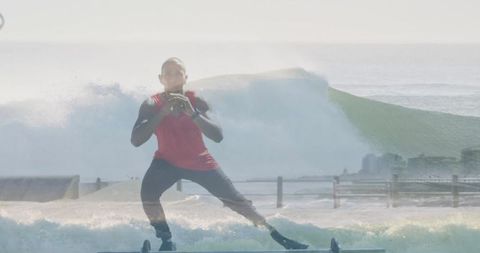 Man balancing on board near ocean edge showcasing dynamic fitness