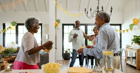 Joyful Senior Friendship at Birthday Celebration in Living Room