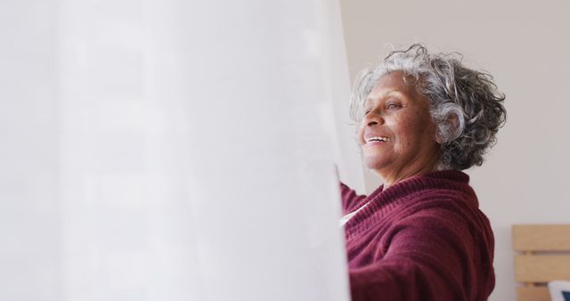 Senior Woman Opening Curtains and Smiling Joyfully - Download Free Stock Images Pikwizard.com