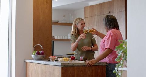 Mother and Daughter Sharing Toast in Cozy Kitchen Setting