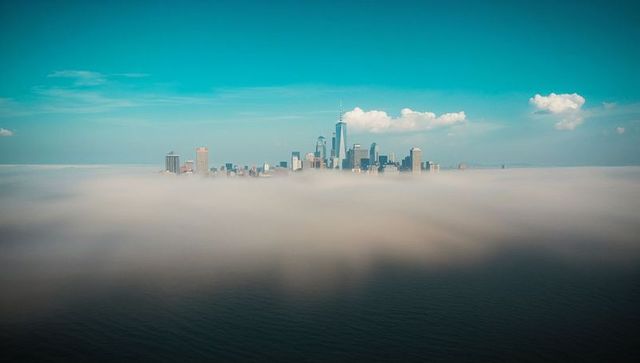 Skyline emerges through low-lying fog