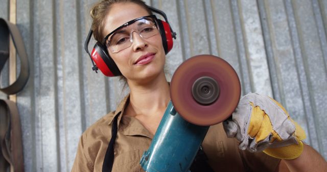 Female Factory Worker Using Power Tool With Safety Gear - Download Free Stock Images Pikwizard.com