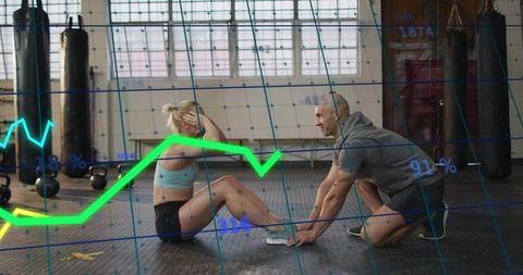 Woman doing sit-ups with trainer holding feet in gym with neon performance metrics overlay