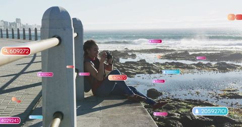 Hobbyist photographer capturing tidepools on sunny coastal promenade with ar overlays