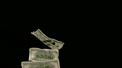 Floating U.S. Dollar Bills on Black Background