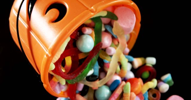 Close-up of various confectioneries spilling out from halloween bucket 4k
