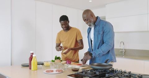 Father and son bonding over homemade burger preparation