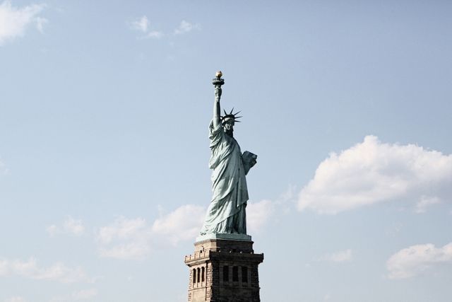 Statue of Liberty against Blue Sky - Download Free Stock Photos Pikwizard.com