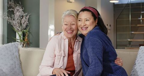 Senior Couple Embracing on Cozy Sofa in Warm Living Room