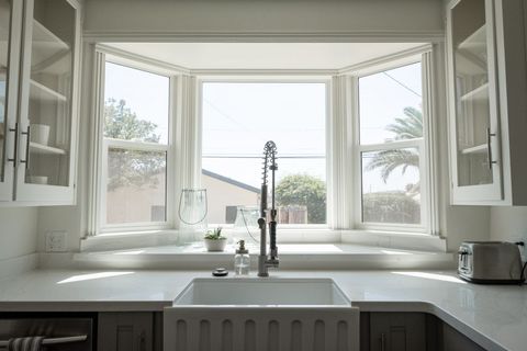 Sunny Kitchen with Large Bay Window and Farmhouse Sink