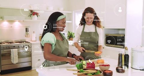 Two women chopping vegetables on bright modern kitchen island with smart hud overlays